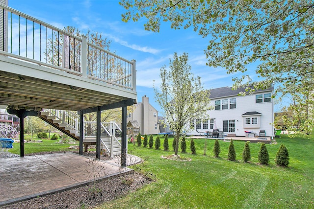 4261 Merriman Loop, Howell, MI 48843 - view of green lawn featuring a patio area, a deck, and stairs