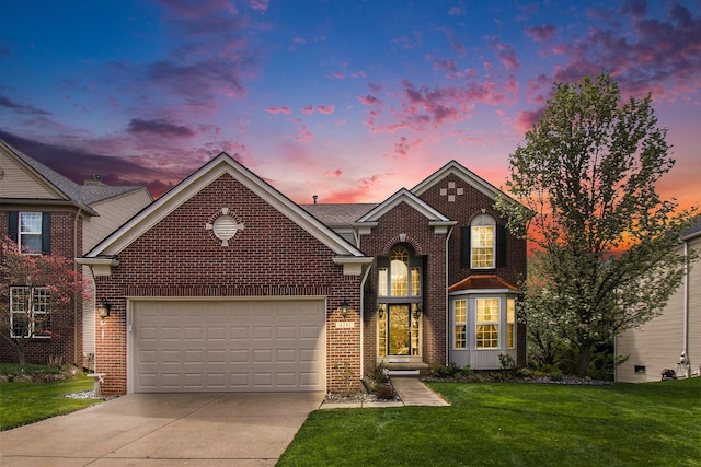 4261 Merriman Loop, Howell, MI 48843 - traditional home featuring driveway, a garage, a front lawn, and brick siding