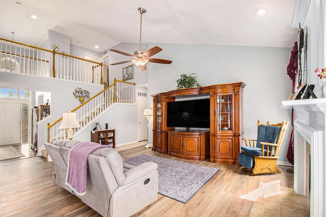 4261 Merriman Loop, Howell, MI 48843 - living area featuring ceiling fan, stairs, wood finished floors, recessed lighting, and high vaulted ceiling