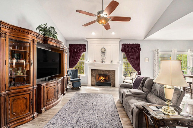 4261 Merriman Loop, Howell, MI 48843 - living area featuring lofted ceiling, ceiling fan, light wood-type flooring, a fireplace, and recessed lighting