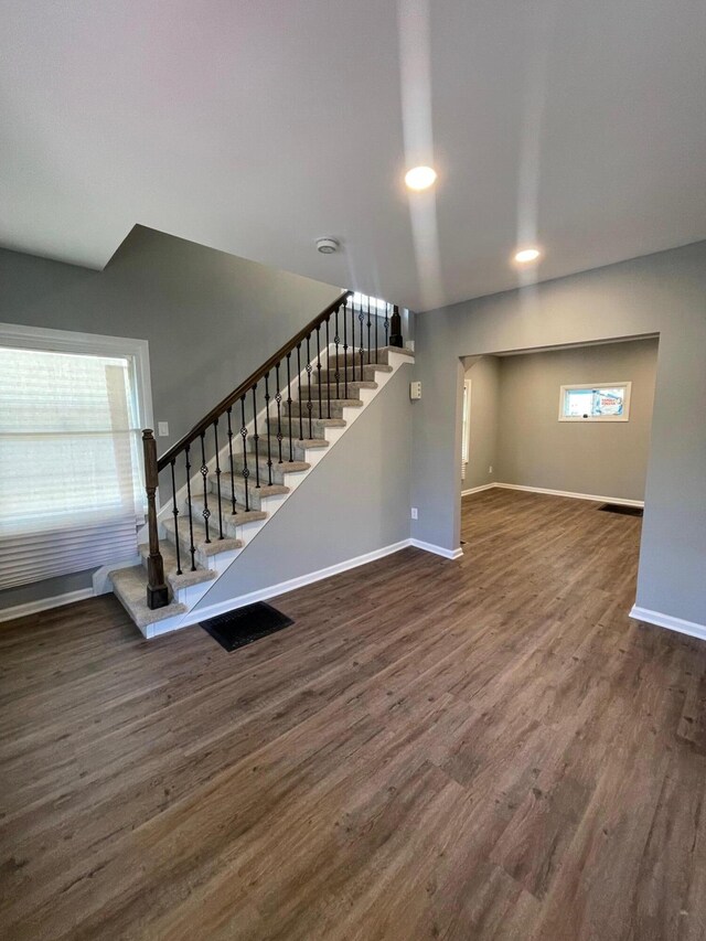 206 Mitchell St, Jackson, MI 49203 - unfurnished living room featuring stairs, baseboards, dark wood finished floors, and recessed lighting