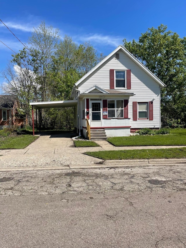 206 Mitchell St, Jackson, MI 49203 - view of front of property with an attached carport, driveway, and covered porch