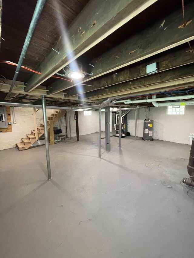 206 Mitchell St, Jackson, MI 49203 - basement featuring stairway, electric water heater, electric panel, and heating unit