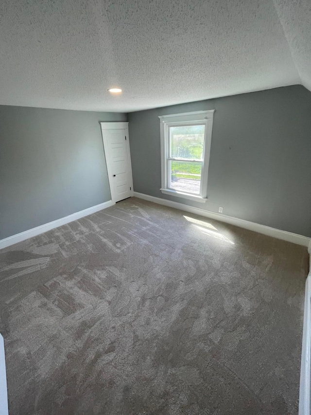 206 Mitchell St, Jackson, MI 49203 - unfurnished bedroom featuring baseboards, a textured ceiling, and carpet flooring