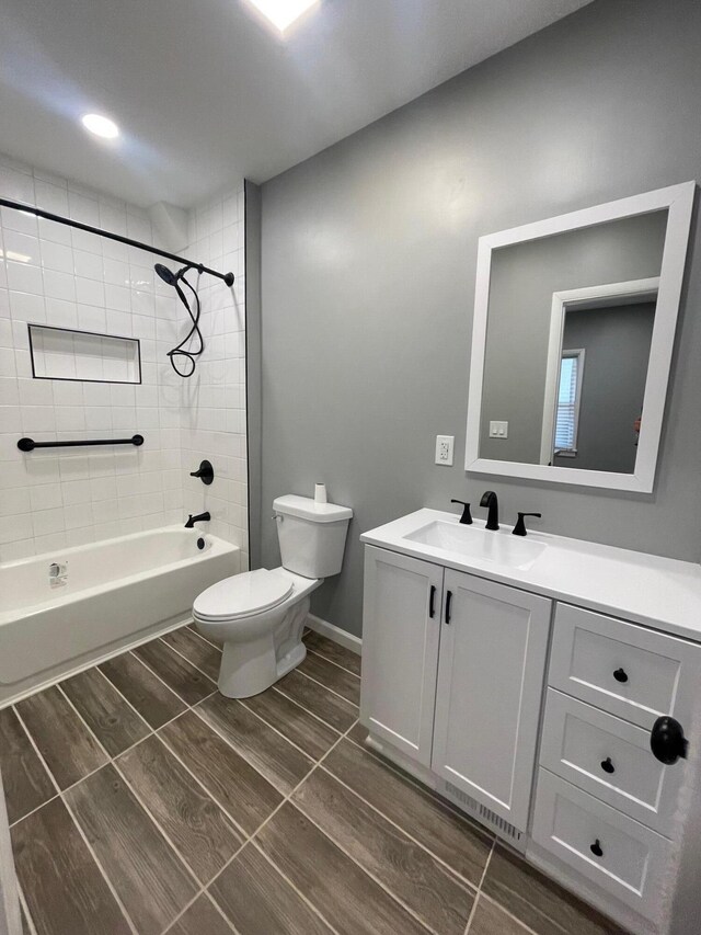 206 Mitchell St, Jackson, MI 49203 - full bathroom with toilet, vanity, bathing tub / shower combination, and wood tiled floors
