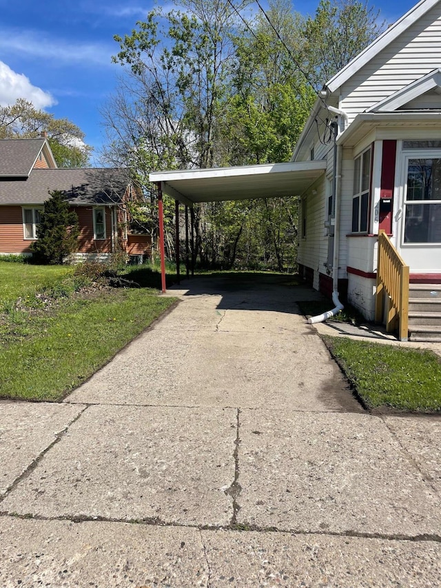 206 Mitchell St, Jackson, MI 49203 - view of property exterior with driveway, entry steps, and an attached carport