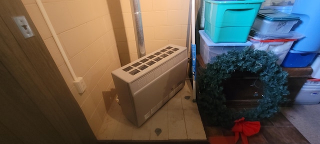4131 W Meisenheimer Rd, Ludington, MI 49431 - clothes washing area featuring heating unit and concrete block wall