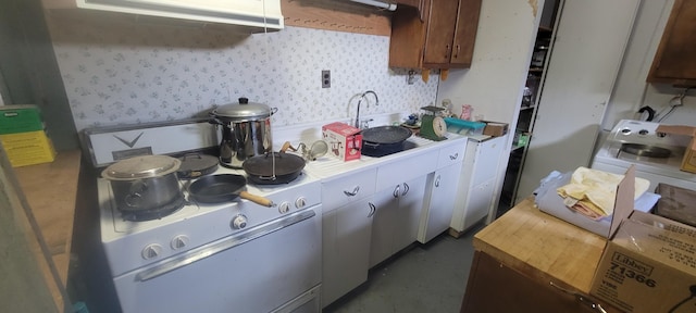 4131 W Meisenheimer Rd, Ludington, MI 49431 - kitchen with a sink, white electric range, wallpapered walls, concrete floors, and butcher block counters
