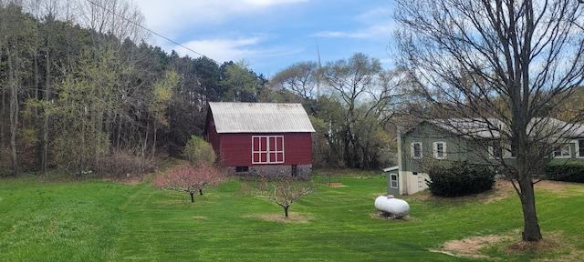 4131 W Meisenheimer Rd, Ludington, MI 49431 - view of grassy yard with an outdoor structure, a barn, and a wooded view