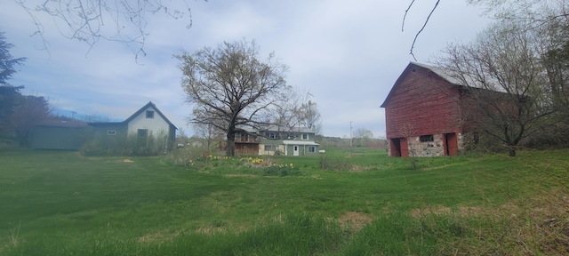 4131 W Meisenheimer Rd, Ludington, MI 49431 - view of grassy yard featuring a barn and an outdoor structure