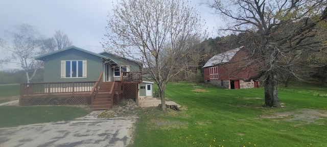 4131 W Meisenheimer Rd, Ludington, MI 49431 - view of front of property with a front yard and a deck