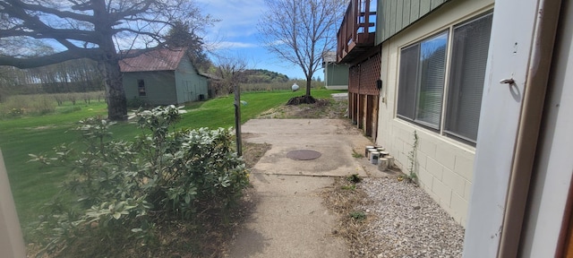 4131 W Meisenheimer Rd, Ludington, MI 49431 - view of grassy yard with a patio and a balcony