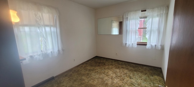4131 W Meisenheimer Rd, Ludington, MI 49431 - empty room featuring dark carpet and baseboards