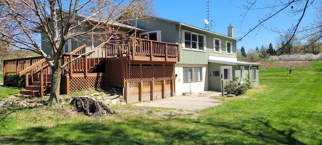4131 W Meisenheimer Rd, Ludington, MI 49431 - rear view of house featuring a deck, a yard, a chimney, stairway, and an attached garage
