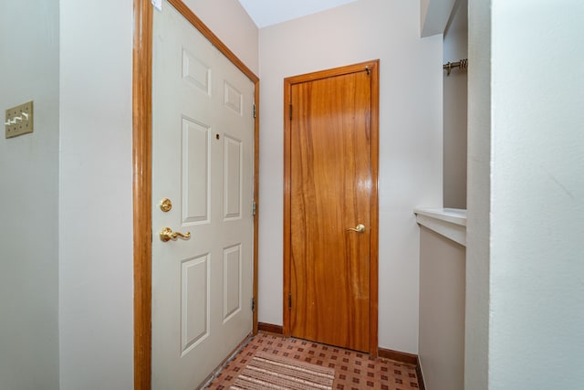 entryway featuring baseboards and light floors