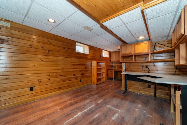 home office featuring wood walls, recessed lighting, dark wood-style flooring, and a paneled ceiling