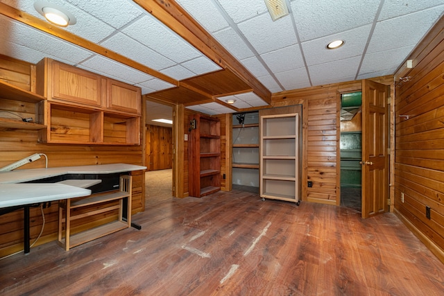 office space featuring dark wood-type flooring, wooden walls, and recessed lighting
