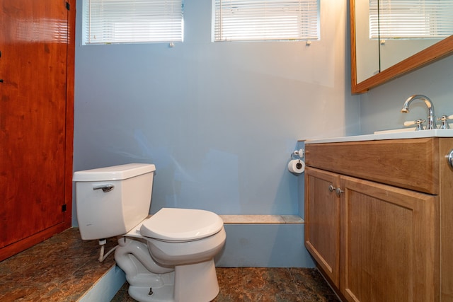 half bathroom featuring toilet and vanity