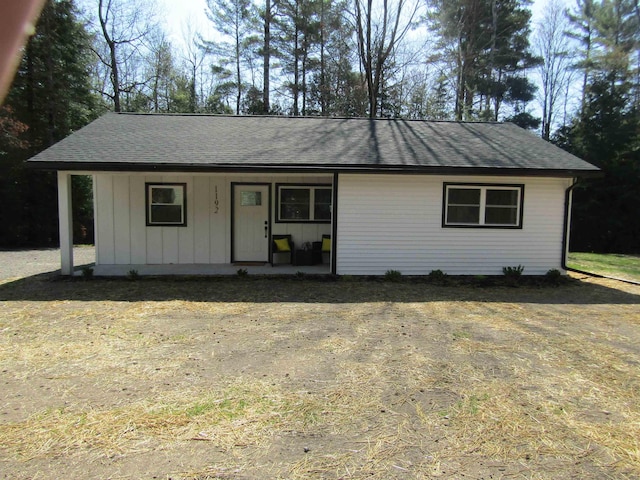 1192 Little Creek Rd SE, Alger, MI 48610 - single story home with a porch, roof with shingles, and board and batten siding