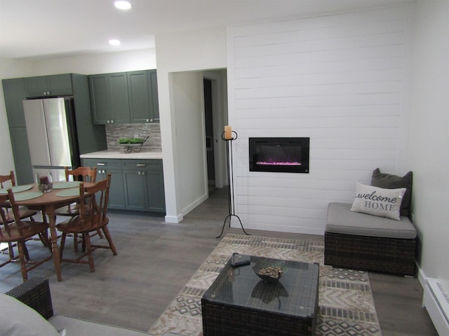 1192 Little Creek Rd SE, Alger, MI 48610 - living area featuring light wood finished floors, recessed lighting, a glass covered fireplace, and baseboards