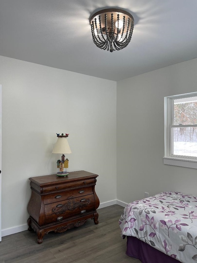 1192 Little Creek Rd SE, Alger, MI 48610 - bedroom featuring wood finished floors, baseboards, and a chandelier