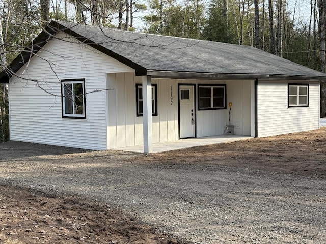 1192 Little Creek Rd SE, Alger, MI 48610 - single story home with a shingled roof and covered porch
