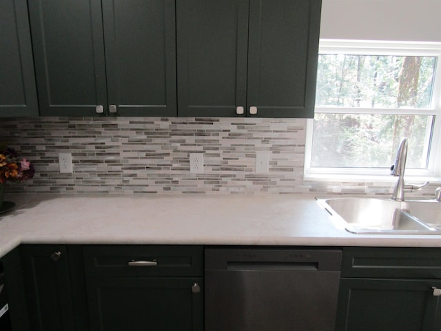 1192 Little Creek Rd SE, Alger, MI 48610 - kitchen featuring dishwasher, a sink, backsplash, and light countertops
