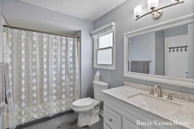 full bathroom featuring toilet, tile patterned floors, vanity, and a shower with shower curtain