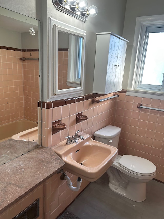 3608 W Webster Rd, Royal Oak, MI 48073 - full bathroom featuring tile walls, toilet, tile patterned floors, a sink, and wainscoting
