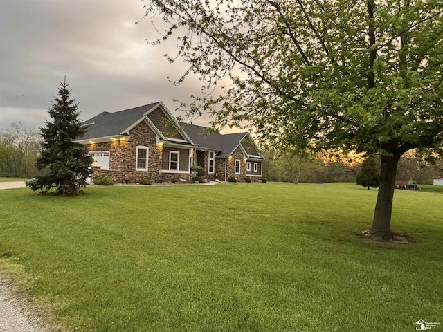 craftsman house featuring stone siding and a front yard
