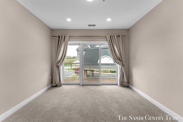 spare room with carpet floors, baseboards, and recessed lighting