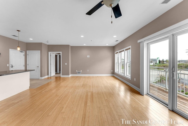 unfurnished living room featuring ceiling fan, light wood-style flooring, recessed lighting, and baseboards
