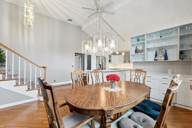 9669 Norman Rd, Clarkston, MI 48348 - dining room featuring light wood-style floors, high vaulted ceiling, a chandelier, a baseboard heating unit, and a ceiling fan