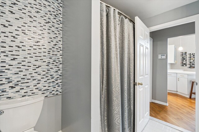 9669 Norman Rd, Clarkston, MI 48348 - bathroom with tile patterned floors, toilet, vanity, and baseboards