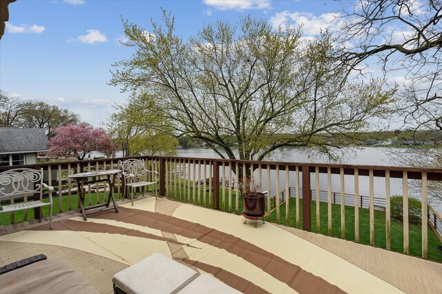 9669 Norman Rd, Clarkston, MI 48348 - wooden terrace with a water view and a lawn