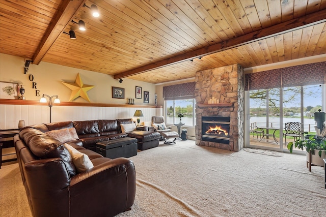 9669 Norman Rd, Clarkston, MI 48348 - living area with carpet, beamed ceiling, a stone fireplace, wooden ceiling, and a water view