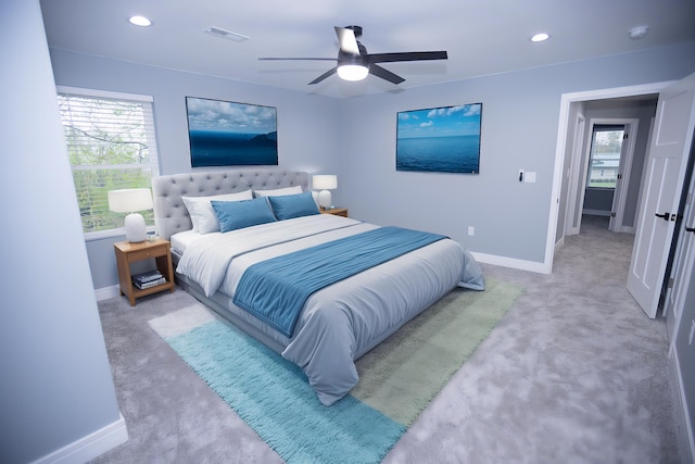 bedroom featuring baseboards, multiple windows, and recessed lighting