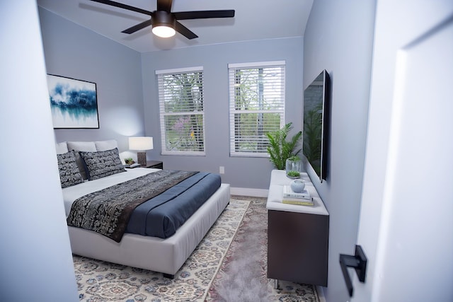 bedroom featuring baseboards and ceiling fan