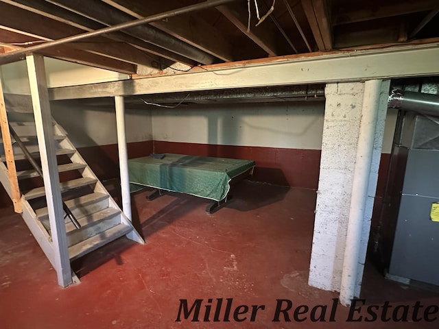 unfinished below grade area featuring stairs