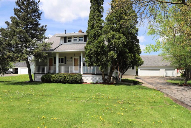 view of front of home featuring a porch, a front lawn, and a chimney