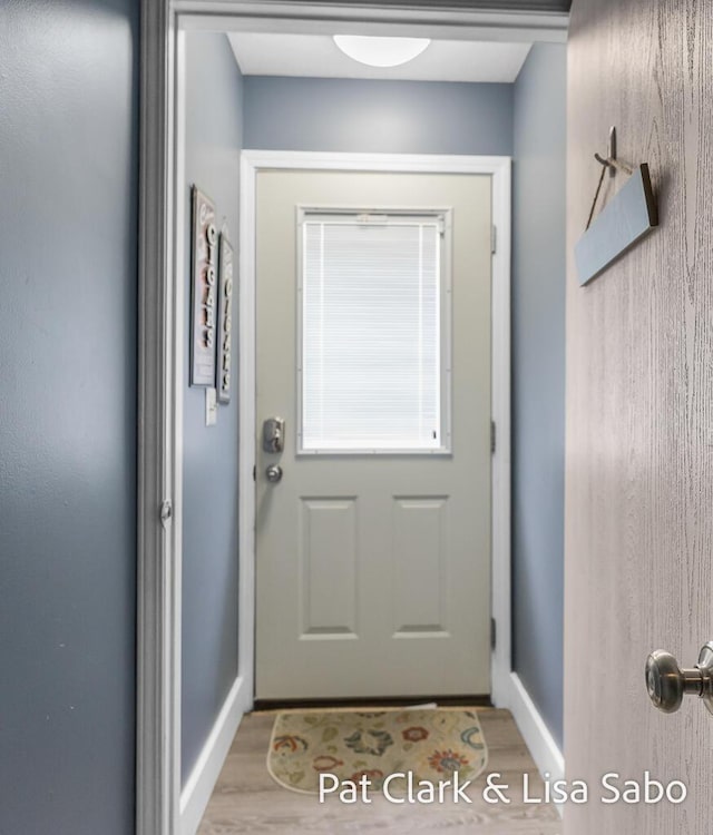 doorway to outside with wood finished floors