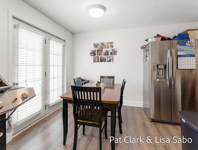 dining room with wood finished floors and baseboards