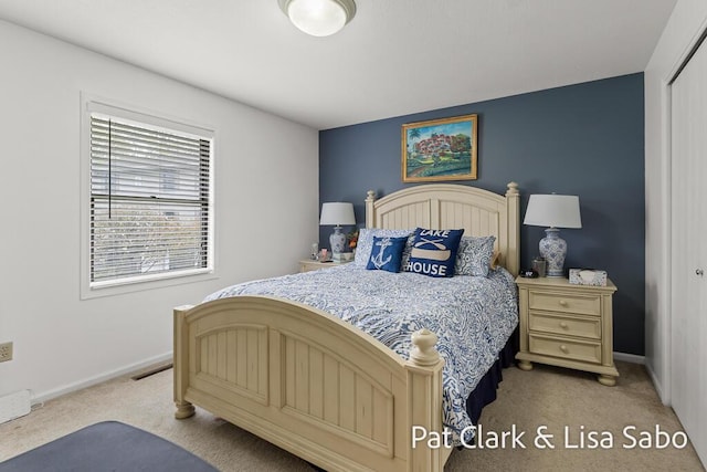 bedroom featuring light colored carpet and baseboards