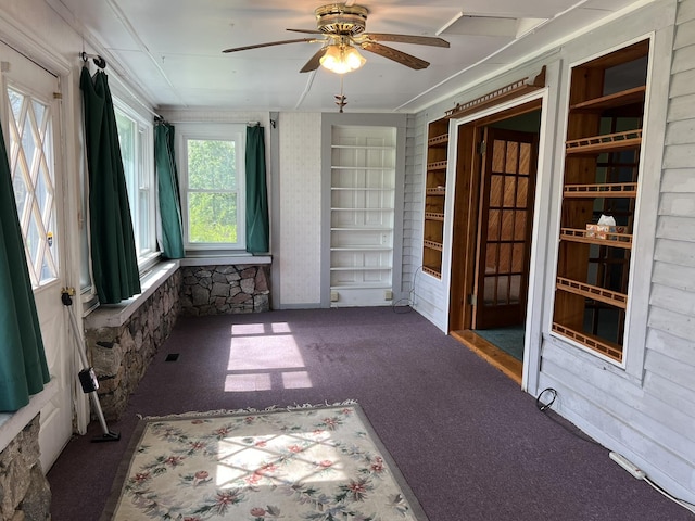 unfurnished sunroom with carpet flooring