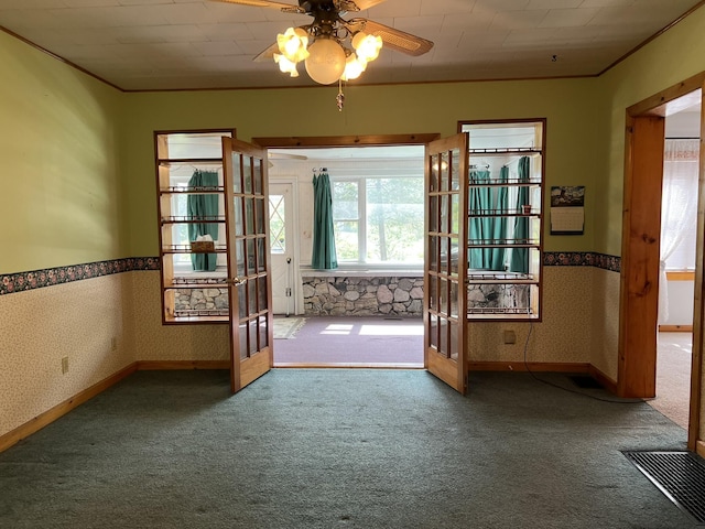 doorway with french doors, carpet, a ceiling fan, crown molding, and baseboards
