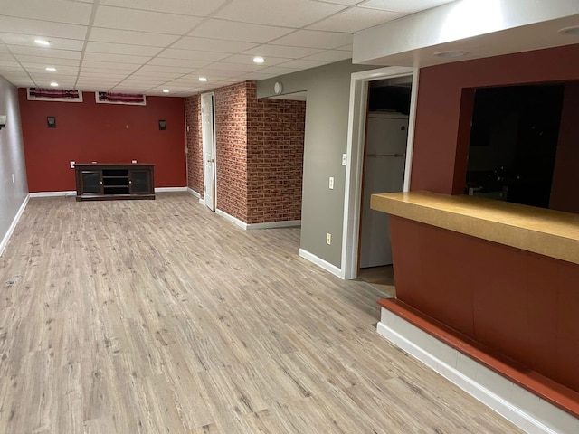 25432 Wexford Ave, Warren, MI 48091 - interior space featuring baseboards, wood finished floors, a drop ceiling, brick wall, and recessed lighting