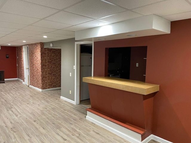 25432 Wexford Ave, Warren, MI 48091 - indoor dry bar featuring a drop ceiling, fridge, baseboards, brick wall, and light wood-type flooring