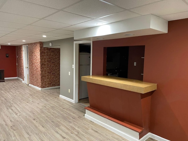 25432 Wexford Ave, Warren, MI 48091 - indoor dry bar with a paneled ceiling, baseboards, brick wall, refrigerator, and light wood-type flooring
