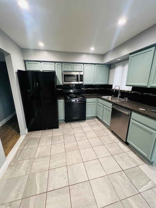 25432 Wexford Ave, Warren, MI 48091 - kitchen featuring black appliances, a sink, green cabinetry, recessed lighting, and baseboards