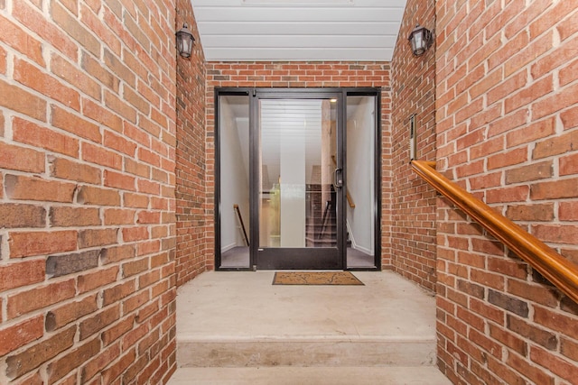 entrance to property with brick siding